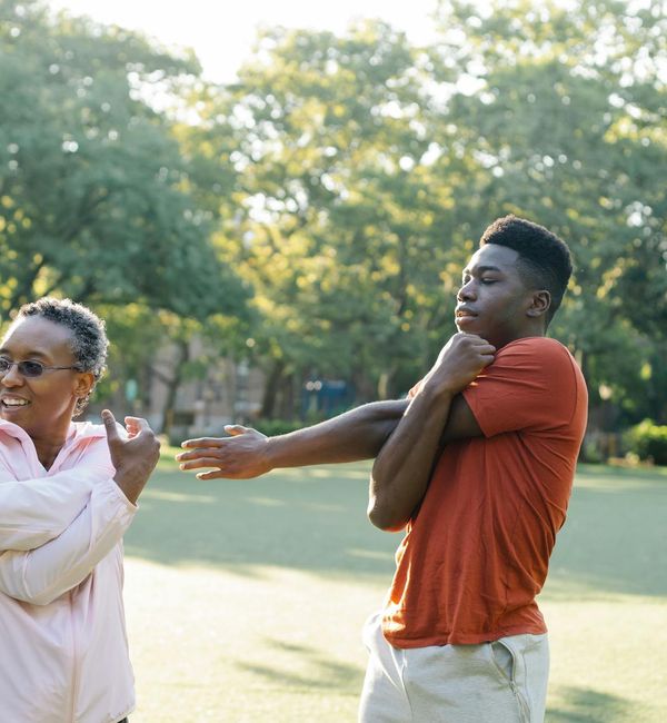 Silhouette of a man stretching at sunrise, symbolizing energy and vitality.